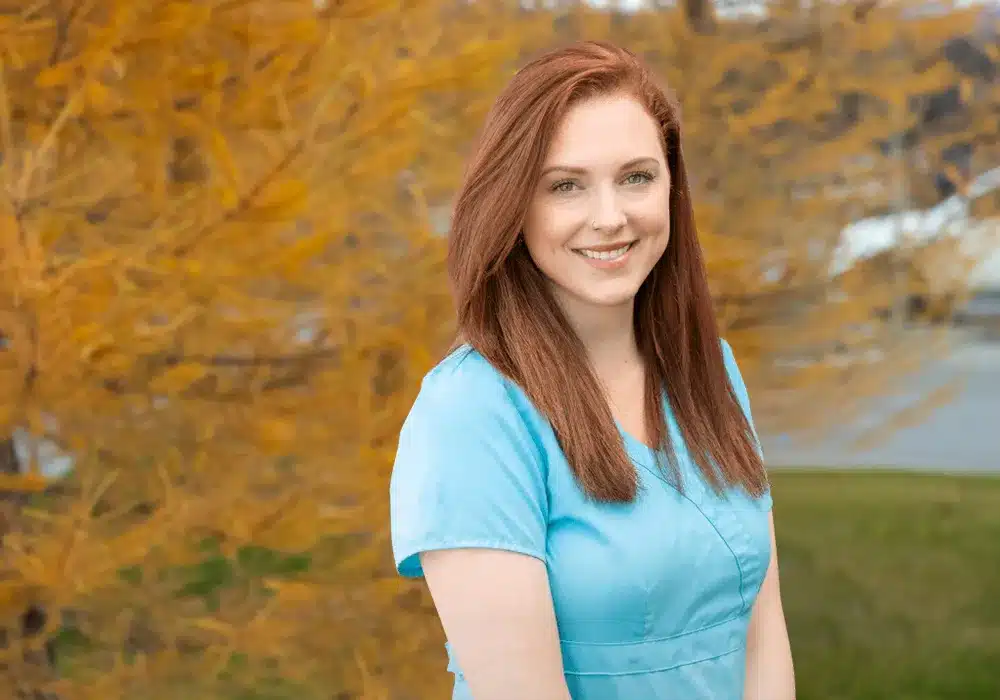 Allison, medical professional in scrubs, outdoor headshot with fall colors in Alaska
