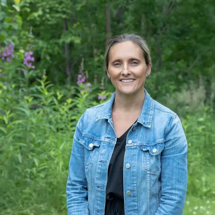 Andrea Rapson outdoor professional headshot among Alaska fireweed