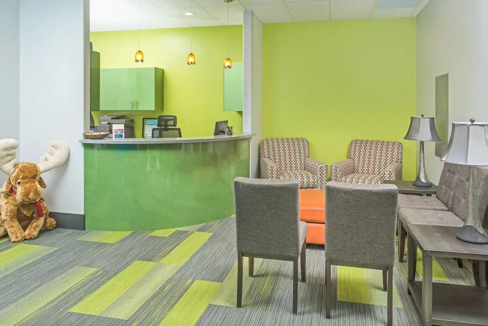 Bright medical clinic waiting room with moose plush, photographed for local SEO in Alaska