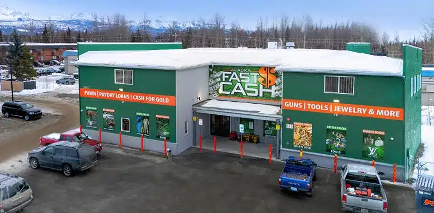 Aerial drone photo of Fast Cash storefront with snowy mountains, FAA Part 107 drone work in Alaska