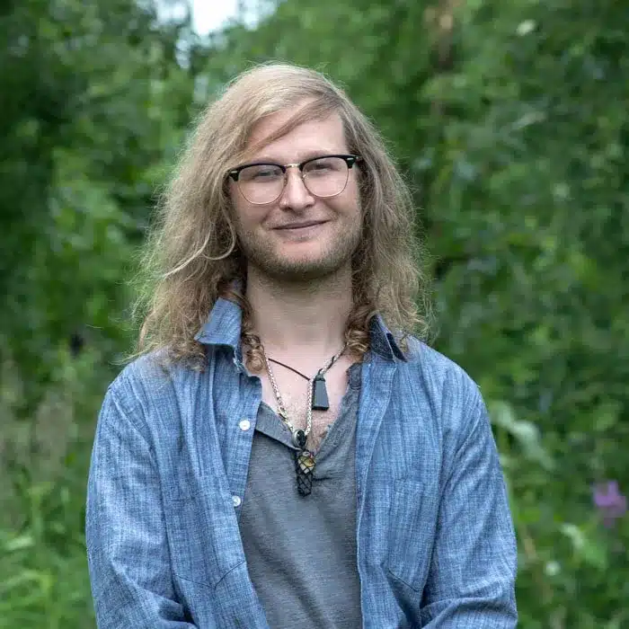 Outdoor professional headshot of a smiling team member in Wasilla, Alaska
