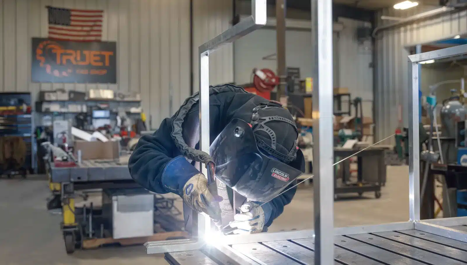 Welder at work in an Alaska fabrication shop, captured for recruiting and commercial video